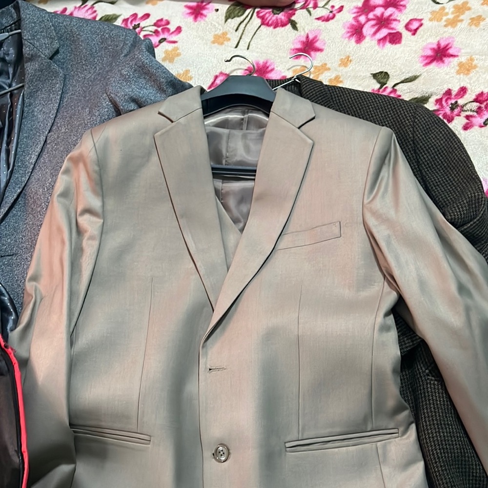 Three piece men’s suit, which includes one coat , one pant and a basket.